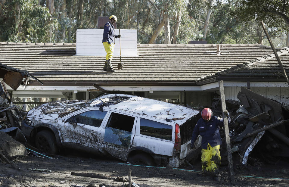 <p>Emergency crew members search an area damaged by storms in Montecito, Calif., Friday, Jan. 12, 2018. (Photo: Marcio Jose Sanchez/AP) </p>