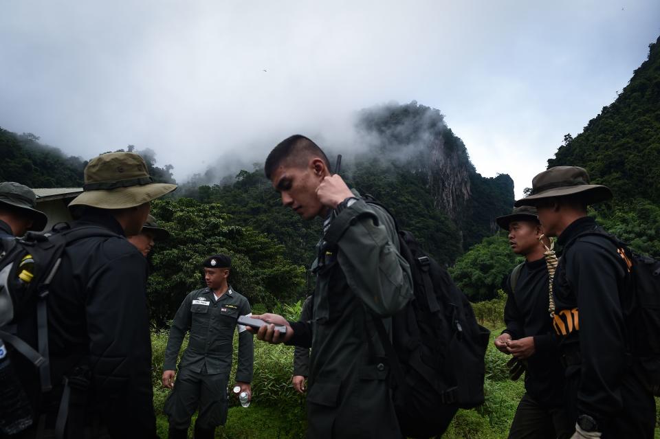 Thai soldiers and police gather in the mountains near the Tham Luang cave at the Khun Nam Nang Non Forest Park in Chiang Rai province on June 30, 2018 as the rescue operation continues for the children of a football team and their coach.