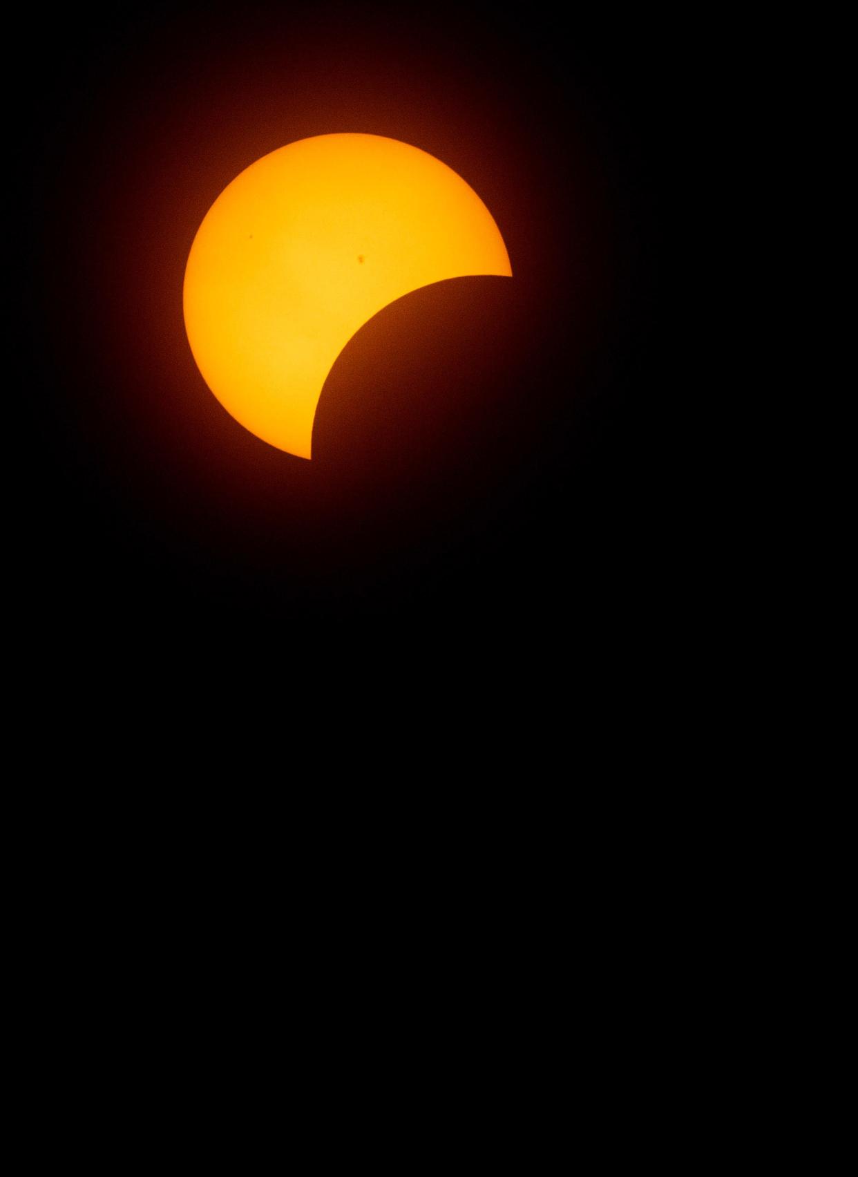 A phase of the solar eclipse on Monday afternoon in downtown Canton.