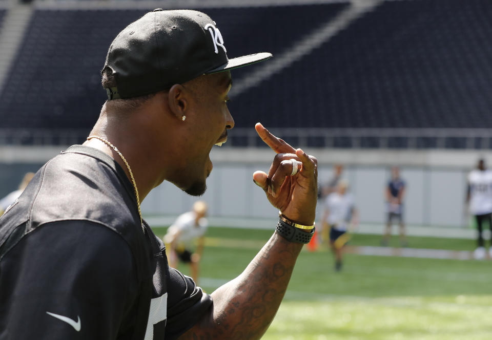 NFL player Tahir Whitehead gestures as he coaches a young team during the final tournament for the UK's NFL Flag Championship, featuring qualifying teams from around the country, at the Tottenham Hotspur Stadium in London, Wednesday, July 3, 2019. The new stadium will host its first two NFL London Games later this year when the Chicago Bears face the Oakland Raiders and the Carolina Panthers take on the Tampa Bay Buccaneers. (AP Photo/Frank Augstein)