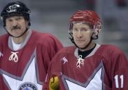 Russia's President Vladimir Putin (R) and his Belarussian counterpart Alexander Lukashenko take part in a friendly ice hockey match in the Bolshoi Ice Palace near Sochi January 4, 2014. Putin has eased curbs on demonstrations in the Winter Olympics venue of Sochi in a gesture likely to burnish Russia's image ahead of an event dogged by security and human rights worries. REUTERS/Alexei Nikolskiy/RIA Novosti/Kremlin (RUSSIA - Tags: POLITICS SPORT OLYMPICS ICE HOCKEY) ATTENTION EDITORS - THIS IMAGE HAS BEEN SUPPLIED BY A THIRD PARTY. IT IS DISTRIBUTED, EXACTLY AS RECEIVED BY REUTERS, AS A SERVICE TO CLIENTS