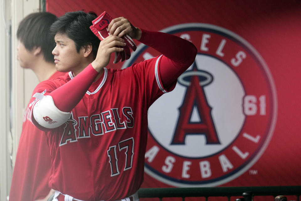 Los Angeles Angels' Shohei Ohtani prepares to bat while in the dugout during the fourth inning of a baseball game against the Miami Marlins, Sunday, May 28, 2023, in Anaheim, Calif. (AP Photo/Marcio Jose Sanchez)