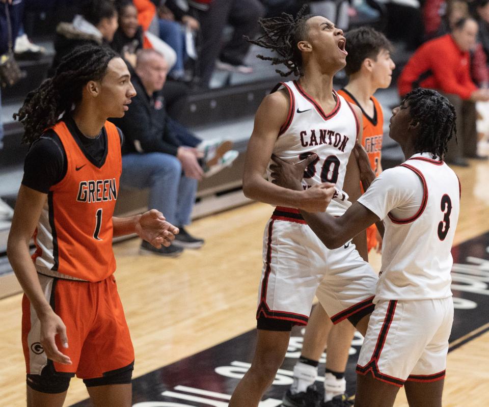 McKinley's Reed Sims Jr. (30) and teammate Jaylen Jeter (3) celebrate beating Green at Memorial Field House after Sims' blocked shot sealed the win, Friday, Jan. 5, 2024.