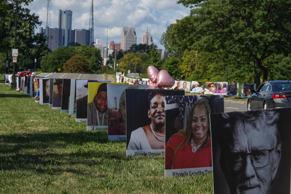 Photos of Detroit residents and people with connections to Detroit who died during the pandemic sit on display as part of the Memorial Drive on Belle Isle in Detroit on Monday, Aug. 31, 2020.