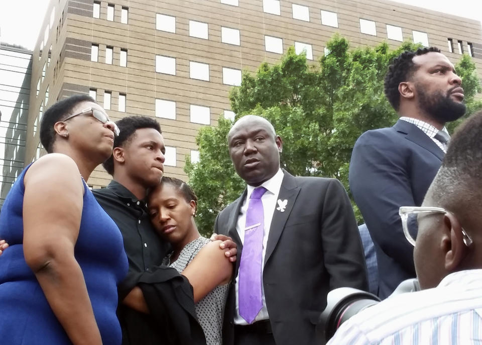 Allison Jean (far left), mother of Botham Shem Jean, stands alongside his brother and sister, as well as family attorneys Benjamin Crump and Lee Merritt, during a news conference on Sept. 10. (Photo: Ryan Tarinelli / AP)