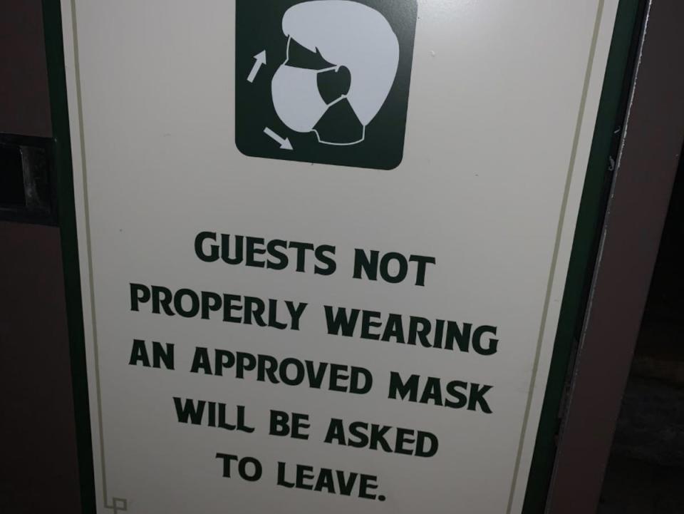 One of the many signs posted throughout Walt Disney World reminding guests to properly wear a face covering