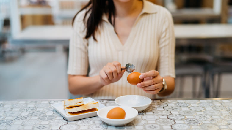 Woman eating an egg