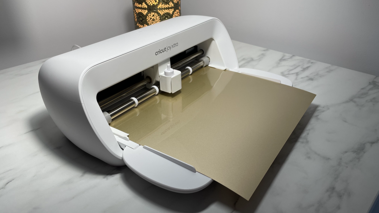  Cricut Joy Xtra review; a small white craft cutting machine on a marble table. 