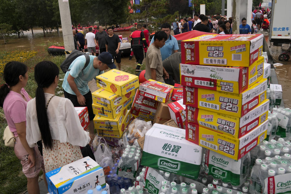 Volunteers prepare food supplies for trapped residents in the flood-hit Zhuozhou in northern China's Hebei province, south of Beijing, Wednesday, Aug. 2, 2023. China's capital has recorded its heaviest rainfall in at least 140 years over the past few days. Among the hardest hit areas is Zhuozhou, a small city that borders Beijing's southwest. (AP Photo/Andy Wong)
