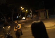 Transgender sex workers wait for customers in Niteroi, Brazil, Saturday, June 27, 2020, amid the new coronavirus pandemic. While some sex workers found refuge, others are stuck on the streets, hustling to earn enough to get by as the economy tanks. (AP Photo/Silvia Izquierdo)