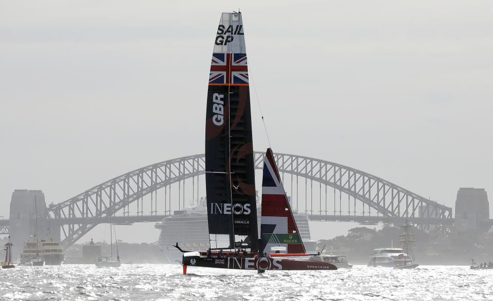 FILE - In this Feb. 29, 2020, file photo, the British team sail in front of the Harbour Bridge during the first fleet race of the SailGP series in Sydney, Australia. SailGP announced Thursday, June 17, 2021, the Australia Sail Grand Prix as the ninth event in the global championship's second season calendar. (AP Photo/Rick Rycroft, File)