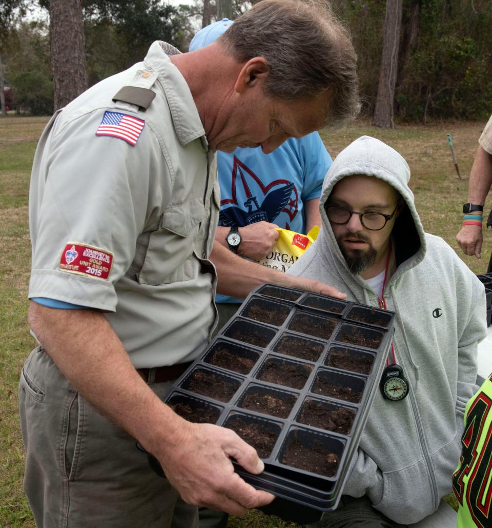 Boy Scout Troop 409 Scout Master Mark Wenzel inspects a tray of seedlings for new growth with Jared Morgan during the Troop's weekly meeting at the St. John's Episcopal Church on Thursday, Feb. 29, 2024. Troop 409 is the area's only Boy Scout troop that caters to special needs members.