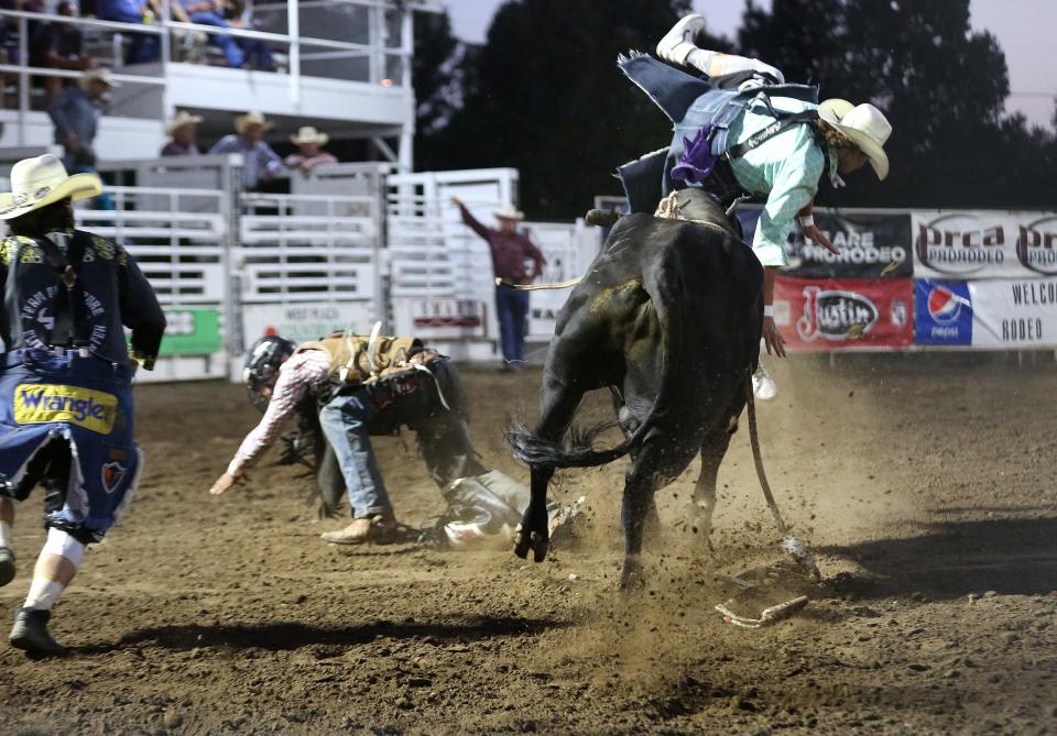 Bullfighter Blake Miller is flipped by a bull as bull rider Coy Pollmeier from Fort Scott gets away during the Bull Riding event during the 76th annual Wild Bill Hickok PRCA Rodeo Bulls, Broncs and Barrels night Wednesday, Aug. 3, 2022, at Eisenhower Park in Abilene.
