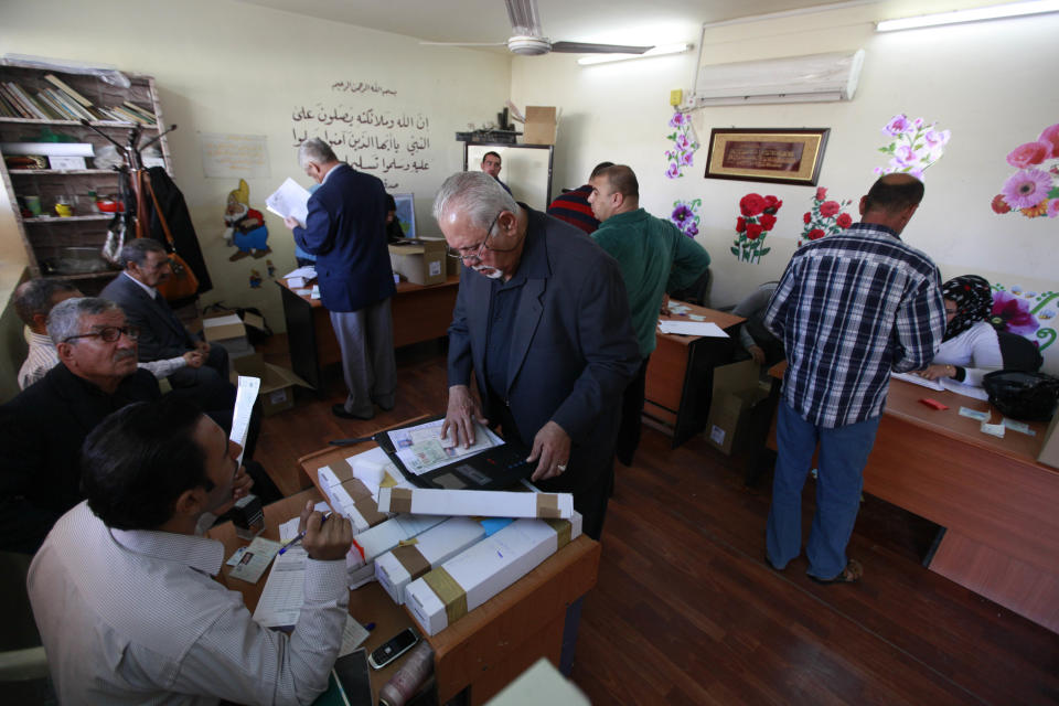 Election officials prepare to distribute voter ID cards to Iraqi citizens in Baghdad, Iraq, Saturday, Feb. 22, 2014. A spokesman for Iraq’s election commission says authorities have begun to distribute voter ID cards in all but one of the country’s 18 provinces, preparing for an April election that will be the first since the 2011 withdrawal of the U.S. forces. (AP Photo/Karim Kadim)