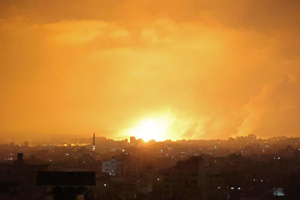 An explosion lights the sky following an Israeli air strike on Beit Lahia in Gaza on Thursday night  (AFP via Getty Images)