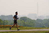 <p>A jogger trots as gaze blankets over monuments on the National Mall in Washington, Wednesday, June 7, 2023, seen from Arlington, Va. Smoke from Canadian wildfires is pouring into the U.S. East Coast and Midwest and covering the capitals of both nations in an unhealthy haze. (AP Photo/Julio Cortez)</p> 