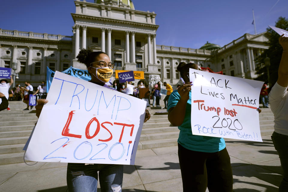 People celebrate outside the Pennsylvania State Capitol in Harrisburg, Pa., after Democrat Joe Biden defeated President Donald Trump to become 46th president of the United States. (AP Photo/Julio Cortez)