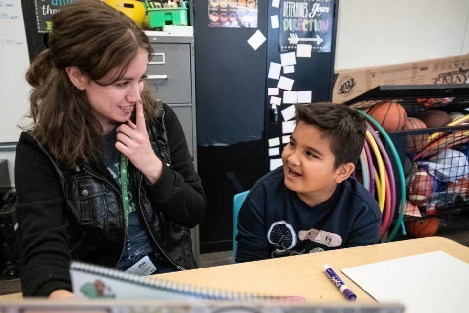 Jessica Seibold with Read On a literacy tutoring program of 916 Ink, gestures to her nose while working with fifth grader Yousuf Ghafari during his tutoring session at F.C. Joyce Elementary School on Nov. 15, 2023.