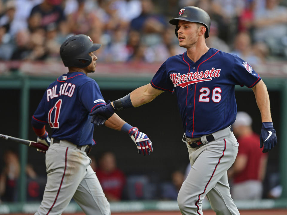 Minnesota Twins' Max Kepler, right, is congratulated by Jorge Polanco after hitting a solo home run off Cleveland Indians starting pitcher Trevor Bauer in the second inning of a baseball game, Saturday, July 13, 2019, in Cleveland. (AP Photo/David Dermer)