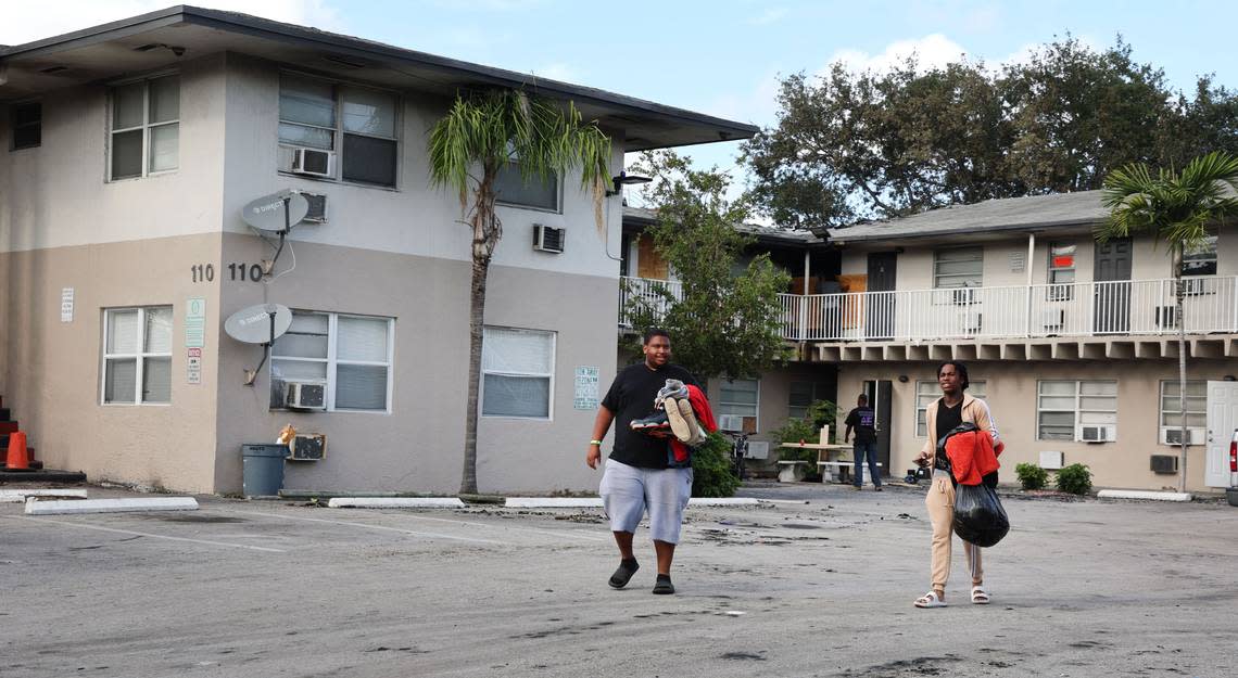 Displaced residents taking whatever was not destroyed from a fire that erupted at an apartment complex in Pompano Beach on Monday May 15, 2023. (Carline Jean/South Florida Sun Sentinel)