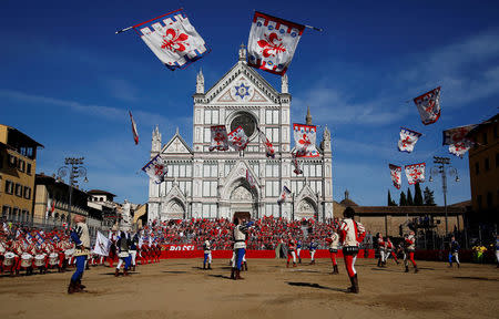 FILE PHOTO - Flag wavers perform in Santa Croce Square before the Calcio Fiorentino (historic football) semifinal match between Rossi (Red) Santa Maria Novella against Verdi (green) San Giovanni in Florence, Italy, June 10, 2017. REUTERS/Alessandro Bianchi /File Photo