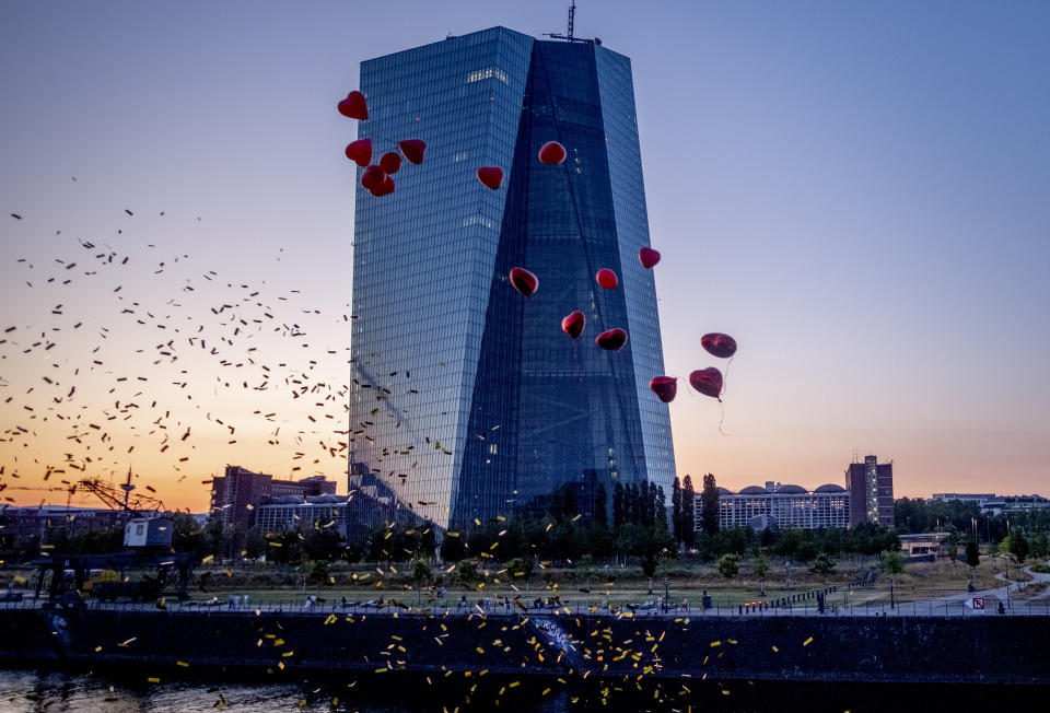 Red balloons sent off from relatives of a bridal couple fly by the European Central Bank in Frankfurt, Germany, Wednesday, June 14, 2023. The governing council of the ECB will meet on Thursday. (AP Photo/Michael Probst)