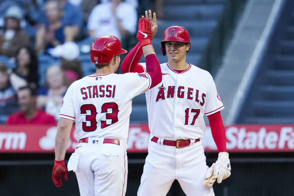 Los Angeles Angels' Max Stassi (33) celebrates with Shohei Ohtani (17) after hitting a home run during the first inning of a baseball game against the Boston Red Sox Tuesday, July 6, 2021, in Anaheim, Calif. (AP Photo/Ashley Landis)