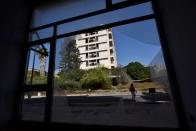 A woman walks in the abandoned coastal area of Varosha