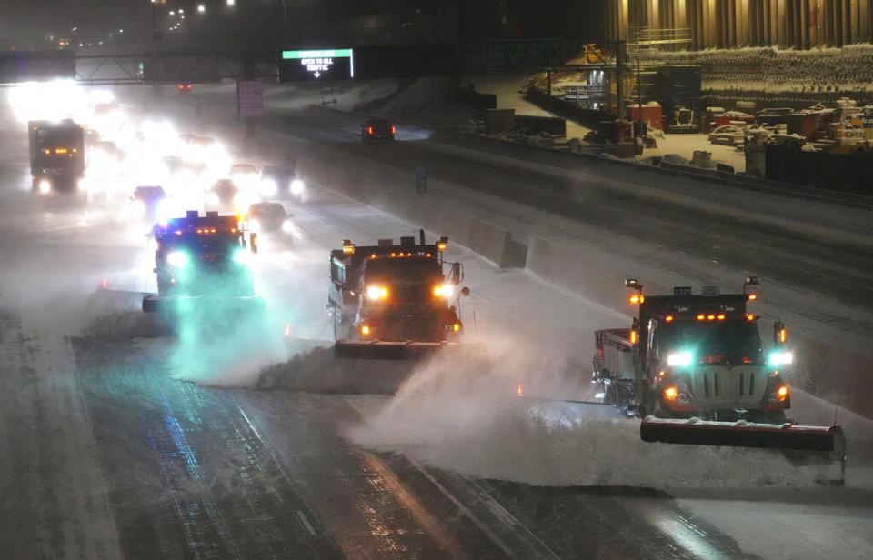 Snow plows move snow from I-35W southbound, seen from the 42nd St. Bridge, as the metro and much of the state prepares for a winter storm, on Wednesday, Feb. 22, 2023 in Minneapolis.<span class="copyright">David Joles–Star Tribune/AP</span>