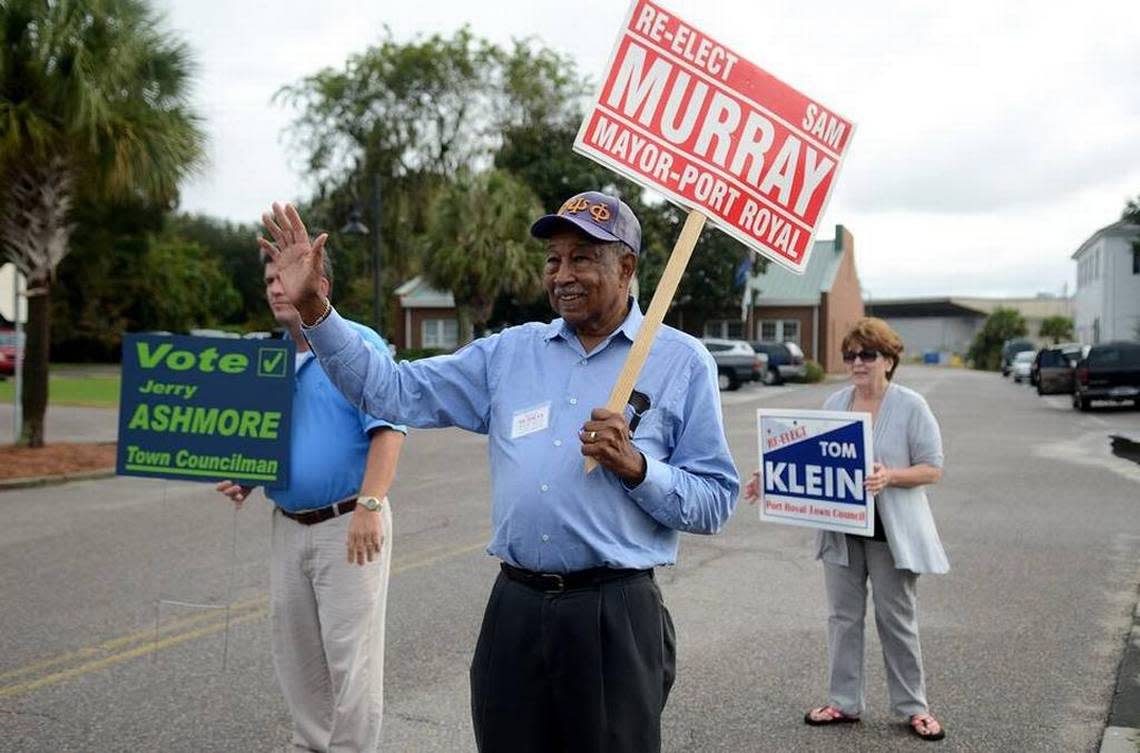 Port Royal Mayor Sam Murray waves to passing cars while campaigning near the polling place at the Port Royal Town Hall on Election Day, Nov. 3, 2015.