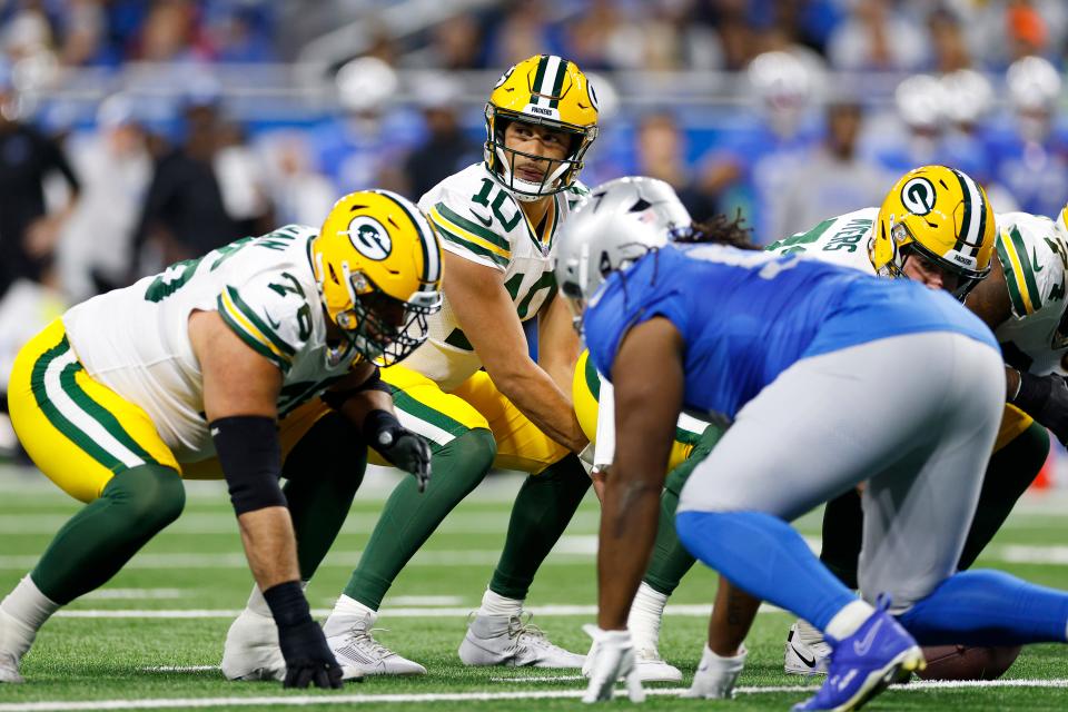 Green Bay Packers quarterback Jordan Love looks on at the line of scrimmage against the Detroit Lions during the first quarter of the Thanksgiving game on Thursday, Nov. 23, 2023, at Ford Field.