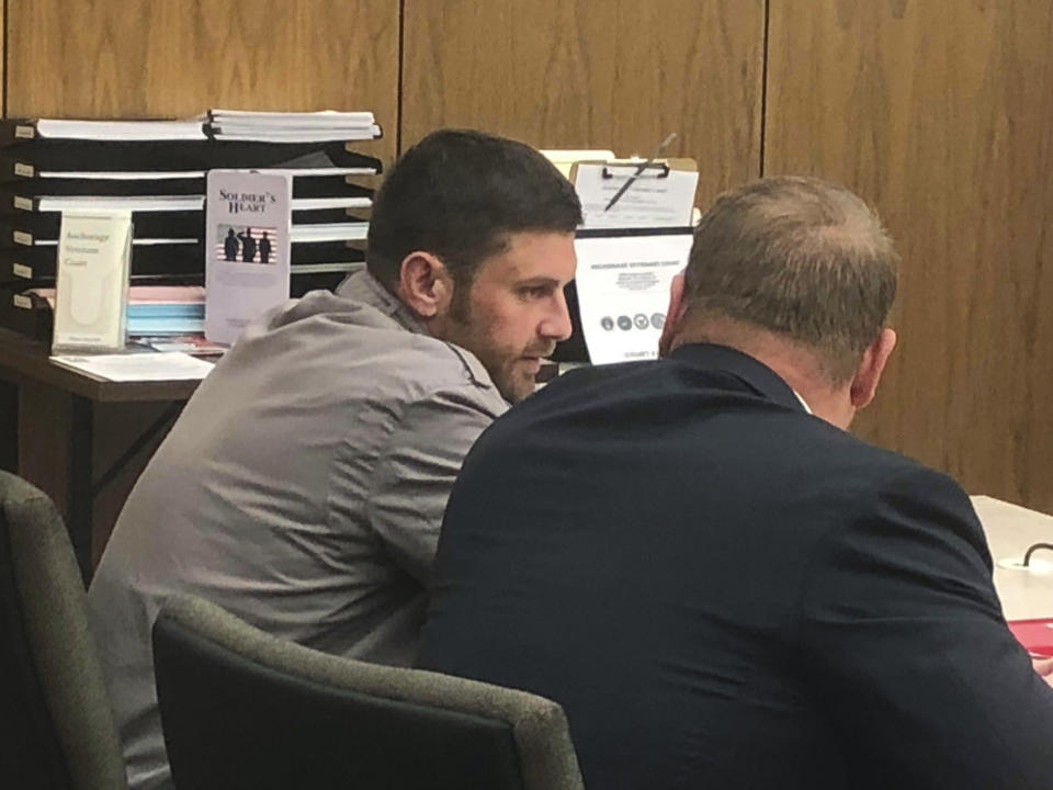 FILE - In this Oct. 3, 2018, file photo, Track Palin, left, talks with his lawyer Patrick Bergt before a hearing in Anchorage, Alaska. The oldest son of former Alaska Gov. Sarah Palin checked in to an Anchorage halfway house Wednesday, Dec. 5, 2018, to begin a year in custody in an assault on his father. Track Palin was initially scheduled to enter the halfway house Oct. 31 after new assault allegations disqualified him from a veterans therapeutic court program. But he won a delay after his lawyer said a bed at a treatment hospital for veterans became available. (AP Photo/Rachel D'Oro, File)