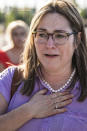 Karmen Swanson gets emotional thinking of her teenager son who is caught in a lockdown shopping by himself at the Mall of America in Bloomington, Minn., on Thursday, Aug. 4, 2022. Police in Minnesota confirm that gunshots were fired at the Mall of America in suburban Minneapolis, but say no victim has been found. (Richard Tsong-Taatarii/Star Tribune via AP)