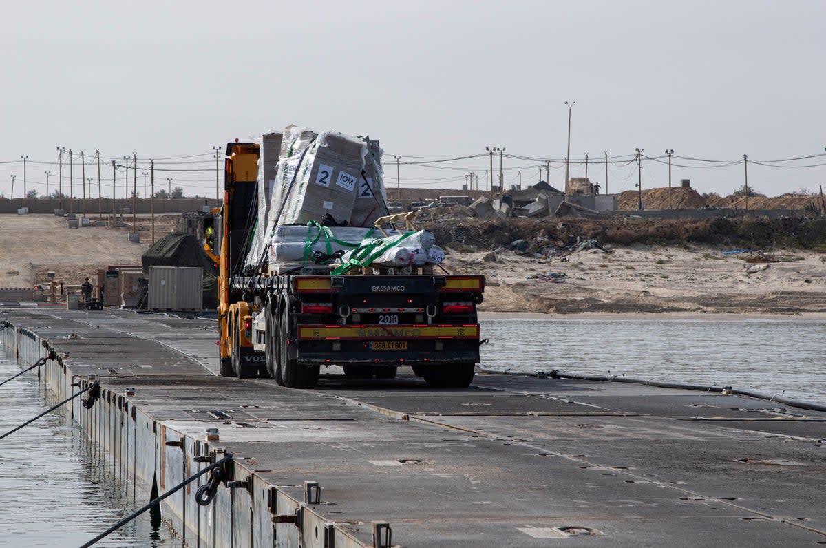 A truck carries humanitarian aid across Trident Pier off the Gaza Strip (via REUTERS)