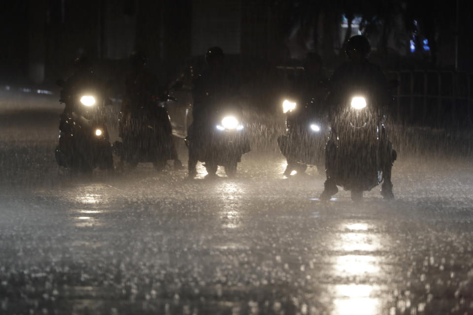 Riders wait at the intersection under heavy rain as the Typhoon Haikui approaches the country, in Taipei, Taiwan, Saturday, Sept. 2, 2023. (AP Photo/Chiang Ying-ying)