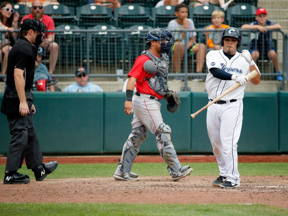 Columbus Clippers catcher Dioner Navarro (17) reacts to being called out on strikes by home plate umpire Skyler Shown behind Pawtucket Red Sox catcher Juan Centeno (2) during the Minor League Baseball game at Huntington Park in Columbus on Thursday, Aug. 8, 2019. The Clippers lost 4-3.