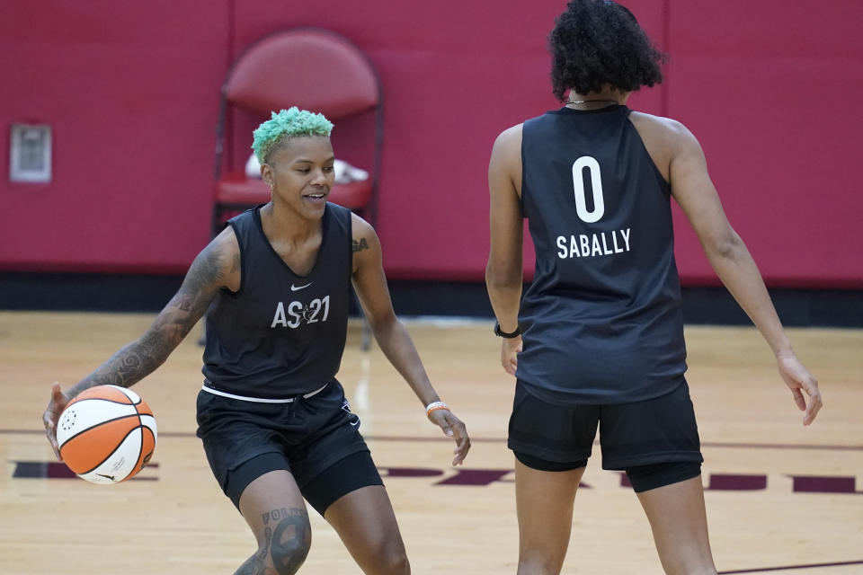 Courtney Williams drives around Satou Sabally during practice for the WNBA All-Star Basketball team, Tuesday, July 13, 2021, in Las Vegas. (AP Photo/John Locher)