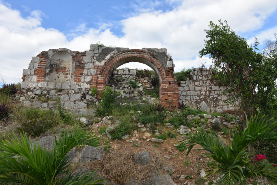 CORRECTS YEAR - In this Jan. 4, 2014 photo, the ruins of a stone house where Rastafarian founding father Leonard P. Howell resided in the 1940s stands in ruins in Sligoville, Jamaica. Rastas are fighting to keep a developer from building on this hilltop, considered sacred to Rastas in southern Jamaica and dubbed "Pinnacle," where Howell founded the first Rastafarian settlement 70 years ago. (AP Photo/David McFadden)