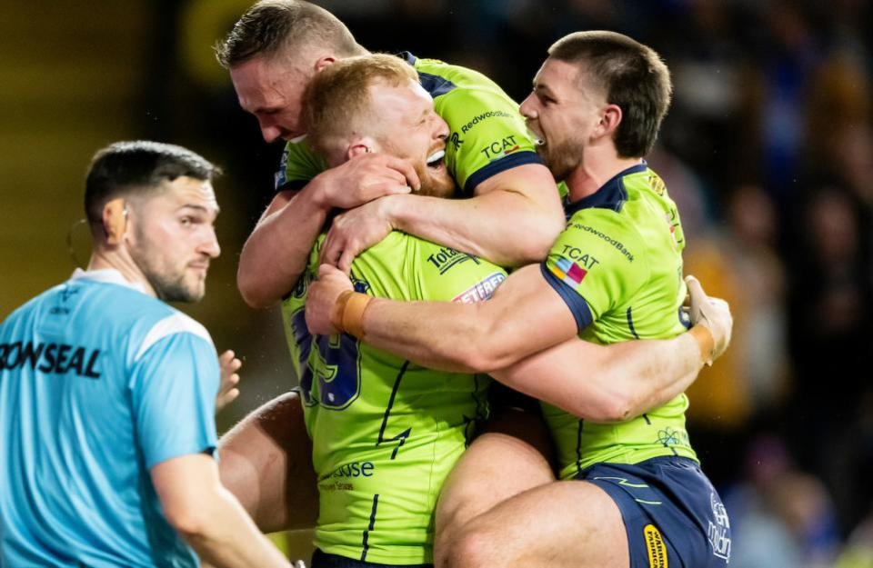 Warrington Guardian: Bullock is congratulated by Ben Currie and Danny Walker after scoring at Leeds last week