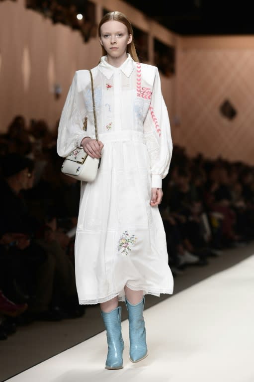 The motif reappears as the patchwork pattern of a flowing white dress that's both girlish and business-like