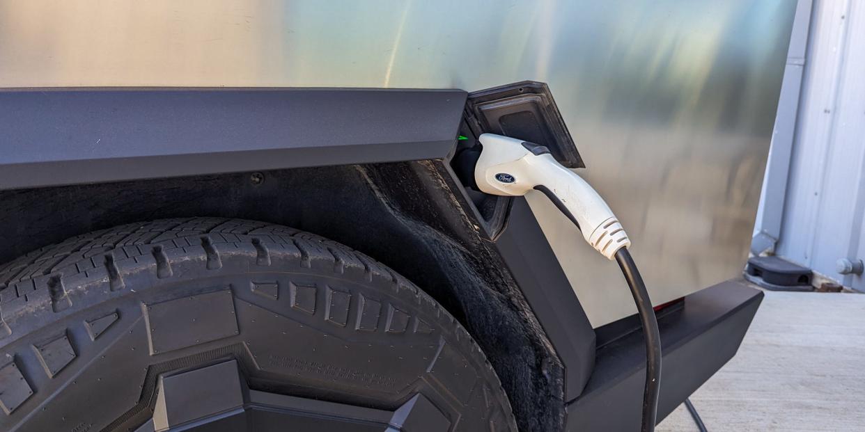 Tesla Cybertruck charging with a Ford-branded plug