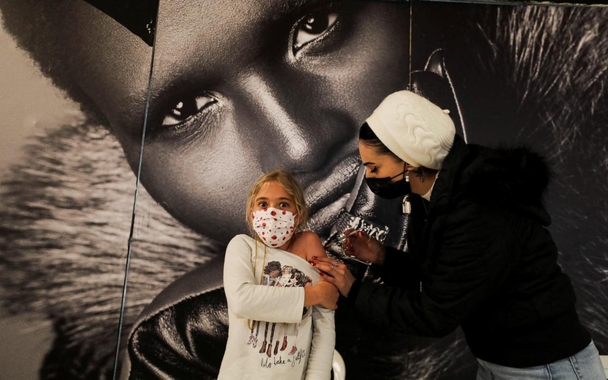 A girl getting the Pfizer jab in Jerusalem - Ammar Awad/Reuters