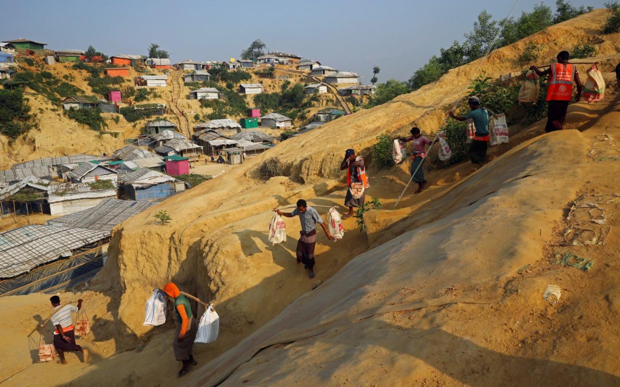 Rohingya refugees carry bricks to a construction site at the Balukhali camp in Cox's Bazar - REUTERS/Mohammad Ponir Hossain/File Photo