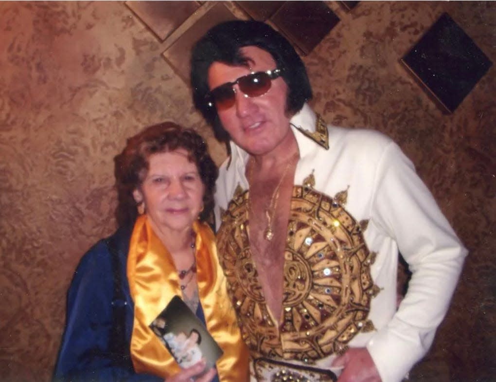 While attending a tribute concert in 2013 at Canton Palace Theatre, Mary Lou Carpinelli had her photograph taken with Elvis impersonator Mike Albert. She is holding a photo of her sister, Janie, had taken with Albert at another concert.