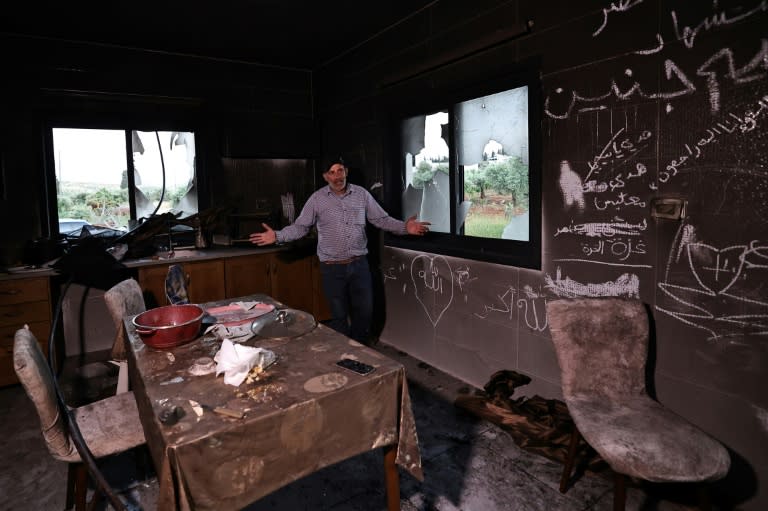 A Palestinian man stands inside his kitchen in the aftermath of an attacked by Israeli settlers (Zain JAAFAR)
