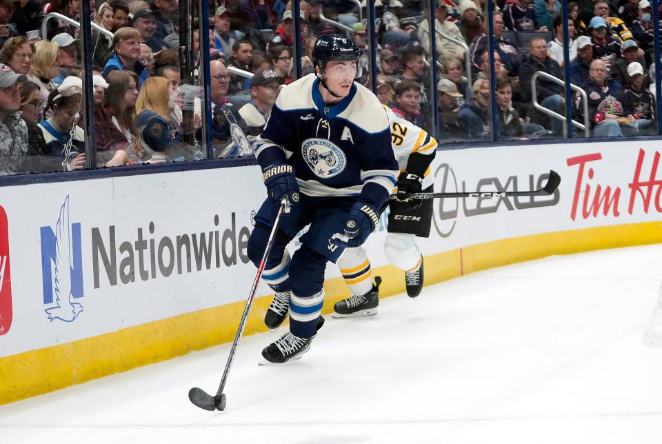 Oct 28, 2022; Columbus, Ohio, USA; Columbus Blue Jackets defenseman Zach Werenski (8) looks to pass the puck against the Boston Bruins in the second period of the NHL game at Nationwide Arena. 