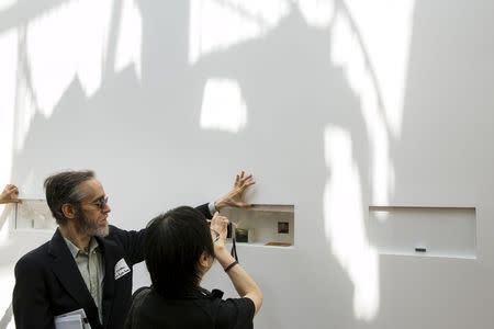 A guest walks past the Yoko Ono exhibit "A Box of Smile" at the Museum of Modern Art exhibition dedicated exclusively to Ono's work, titled "Yoko Ono: One Woman Show, 1960-1971, in New York May 12, 2015. REUTERS/Lucas Jackson