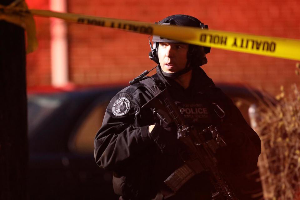 A police officer secures the scene of a shooting in Jersey City that left multiple people dead (Getty Images)