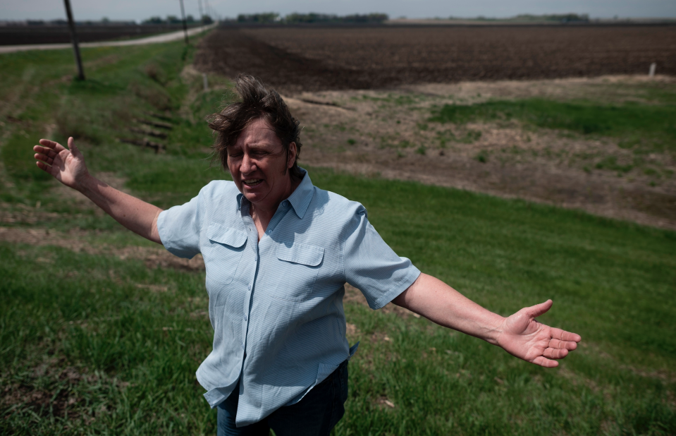 Ruth, wife of farmer Sid Ready, gestures as she stands on the ditch which hold most of the flood water away from their farm near Scribner, Nebraska on May 5, 2019. (Photo: Johannes EISELE / AFP)