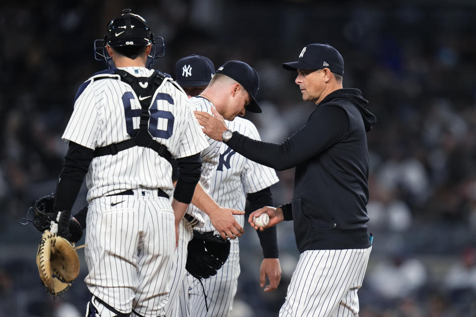 New York Yankees relief pitcher Clay Holmes hands the ball to manager Aaron Boone during the fourth inning of the team's baseball game against the Los Angeles Angels on Tuesday, April 18, 2023, in New York. (AP Photo/Frank Franklin II)